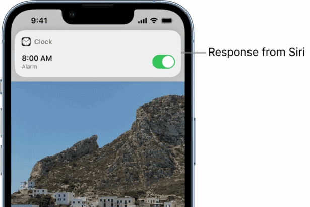 Siri on the Weather app screen. A notification from the Clock app shows that an alarm is turned on for 8:00 a.m. A button at the bottom of the screen is used to continue speaking to Siri.  