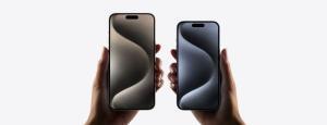 Two models, iPhone 15 Pro Max, iPhone 15 Pro, a hand holds each model, iPhone 15 Pro Max is taller and wider in the hand than iPhone 15 Pro, all screen display, Dynamic Island centered near top, rounded corners.  